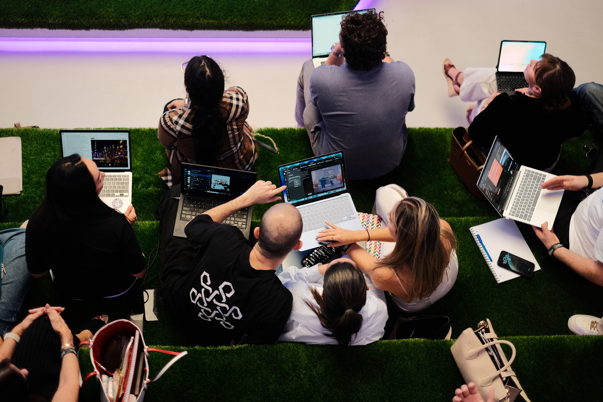 Girls Who AI community members collaborating on laptops together.